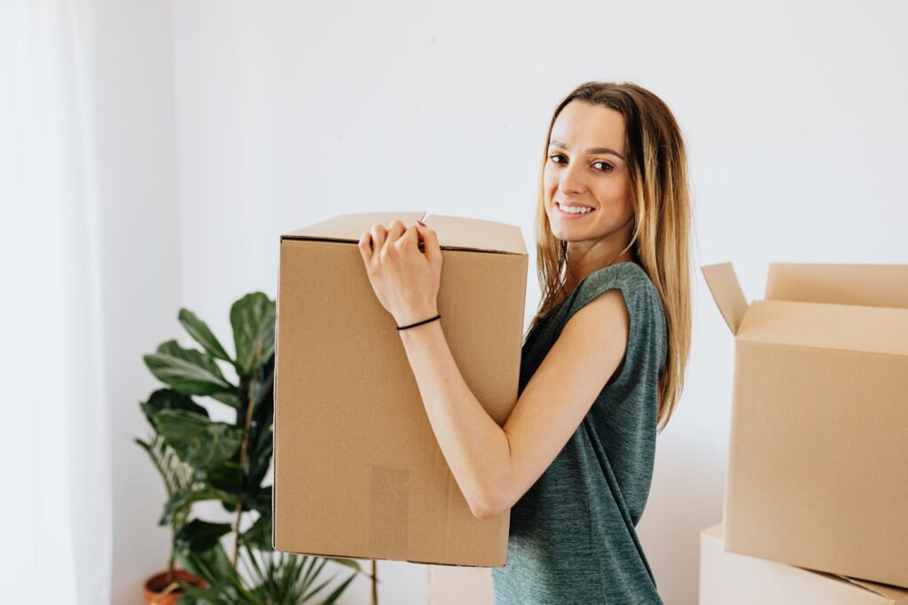 Woman carrying a packed box during a Harrison move