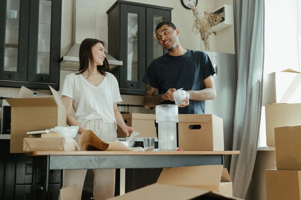 Couple wrapping kitchenware while packing in Harrison, AR
